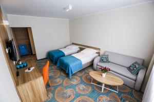 カルビアにあるWilla Jagodaのベッド、ソファ、テーブルが備わる客室です。