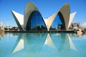 a view of a building with its reflection in the water at Emma Apartment Central in Valencia