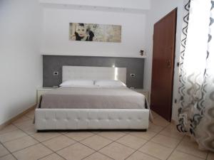 a bedroom with a large white bed in a room at Acquamarina B&B in Martinsicuro