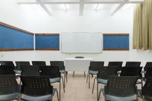 a conference room with a white table and chairs at HI - Tel Hai Hostel in Tel H̱ay