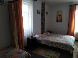 a bedroom with two beds and a window at Diamant in Karlovy Vary