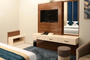 TV at/o entertainment center sa BW Suites & Spa