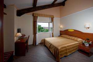 a hotel room with a bed and a window at Hotel Roma Tiburtina Metro in Rome