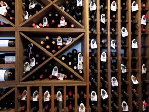 a wall of wine bottles in a wine cellar at The Xara Palace Relais & Chateaux in Mdina