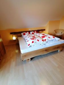 a bedroom with a bed with red roses on it at Ortnerhof in Millstatt