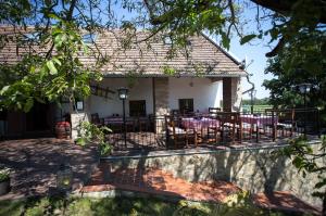 a house with a patio with tables and chairs at Nature House Arany in Zalaszentgrót