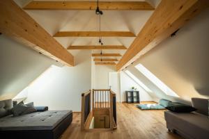 a living room with a couch and wooden ceilings at SKED'N in Bled