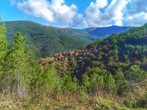 a village on a hill in the mountains at CHR Talasnal in Lousã