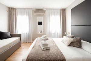 
a hotel room with a bed and a dresser at Locanda Herion in Venice
