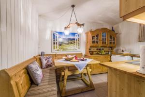 a kitchen with a table and a couch in a room at Zwischen Chiemsee und Bergen Ug in Bernau am Chiemsee