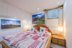 a bedroom with a bed and a window at Zwischen Chiemsee und Bergen Ug in Bernau am Chiemsee