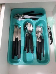 a blue tray with utensils on a table at Apartamento BEIRA-MAR com 2 quartos in Maceió