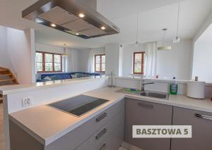 a kitchen with a sink and a counter top at ApartView na Mazurach "Osada Zamkowa" by Rent like home in Pasym