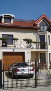 a car parked in front of a house with a garage at Willa Solaris Łeba in Łeba