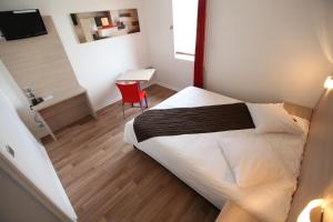 a bedroom with a bed and a desk and a chair at Geneva Residence in Gaillard