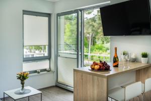 a kitchen with a bowl of fruit on a counter at Baltic Apartments in Pobierowo