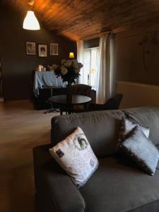 a living room with a couch and a table at Le Relais de Chassepierre in Chassepierre