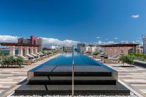 a swimming pool on the roof of a building at Santa Catalina, a Royal Hideaway Hotel in Las Palmas de Gran Canaria