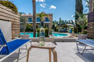 a bottle of wine and two glasses sitting on a table at Holiday Cosy Home in Paphos