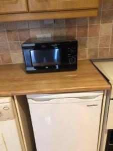 a black microwave sitting on top of a kitchen counter at The Leeson Lodge in Dublin