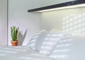 A bed or beds in a room at CIP Hôtel