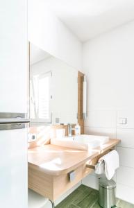 a bathroom with a sink and a mirror at Hotel-Restaurant Sennhütte im Herzen des Südschwarzwalds in Kleines Wiesental