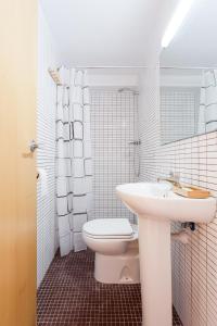 a white bathroom with a sink and a toilet at Marina Boutique Duplex in Sant Antoni de Calonge +25 photos
