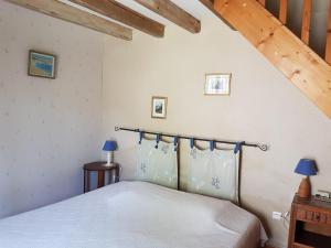 a bedroom with a bed in a room with wooden ceilings at Les Roberderies in Broc