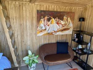 a room with a chair and a painting on the wall at Joly Tiny House in Overijse