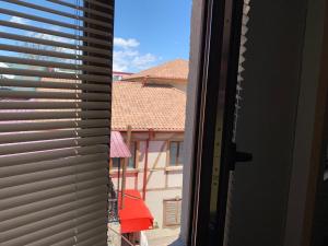 a view from a window with blinds on a building at Old Town Akhaltsikhe in Akhaltsikhe