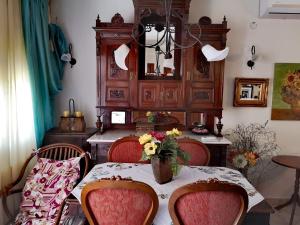 a dining room with a table with a vase of flowers on it at VILLA TASOS in Iraklitsa