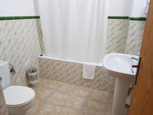a bathroom with a toilet and a sink at Apartamentos La Cabaña in Canyamel