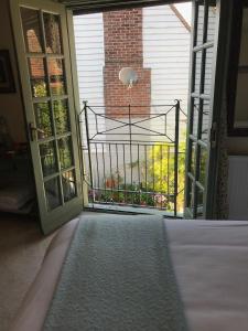 a room with a door open to a balcony at The Tea House in Rye