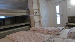 a room with two beds and a chair in it at Nature House Arany in Zalaszentgrót +24 photos