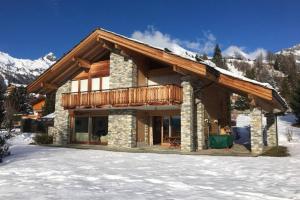 a log cabin in the snow with snow at Chalet La Marendaz in Ovronnaz