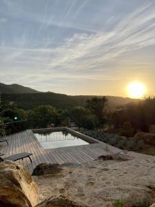 een zwembad met een zonsondergang op de achtergrond bij Villas Celia in Monticello