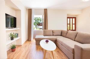 a living room with a couch and a table at Old Stone Villa Lalosevic in Kotor