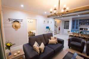 a living room with a couch and a dining room at Sete Cidades Quinta Da Queiró in Sete Cidades
