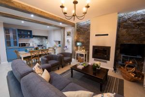 a living room with a couch and a fireplace at Sete Cidades Quinta Da Queiró in Sete Cidades