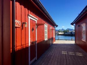 a red brick building with a red door at Anker Brygge in Svolvær