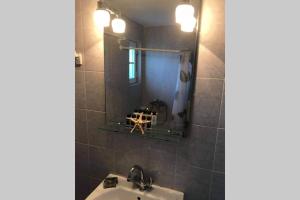 a bathroom with a sink and a mirror at GRAPE YARD APARTMENT in Parikia +9 photos