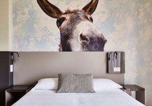 A bed or beds in a room at Hotel La Fenice