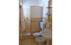 a bathroom with two toilets and a sink at Il GIARDINO della FALENA in Favignana