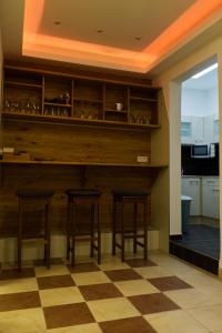 a bar in a kitchen with two stools at KL17 Ostel Döbeln in Döbeln