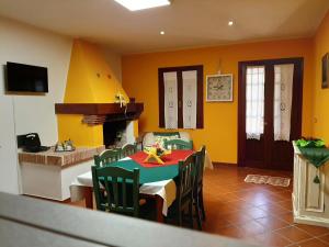 a dining room with a table and chairs and a fireplace at Residence Tenuta Gambalonga in Cinto Euganeo