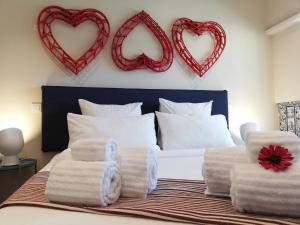 a bedroom with a bed with two hearts on the wall at Lx Art Flats | Flat One in Lisbon
