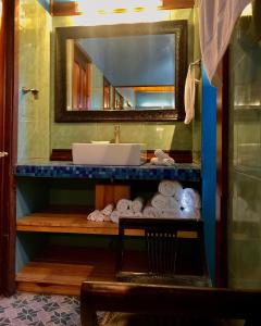 a bathroom with a sink and a pile of towels at Arca de Noe in Valle Hornito