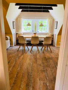 a dining room with a table and chairs at Lindenhof in Tinningstedt