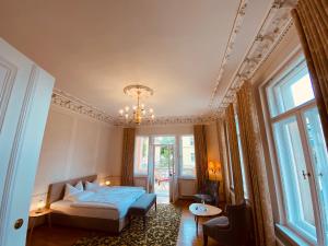 a bedroom with a bed and a chandelier at Villa Antonia in Bautzen