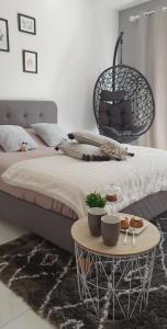 a bedroom with a bed and a table with food on it at Le cosy de sarah in Bordeaux-Saint-Clair